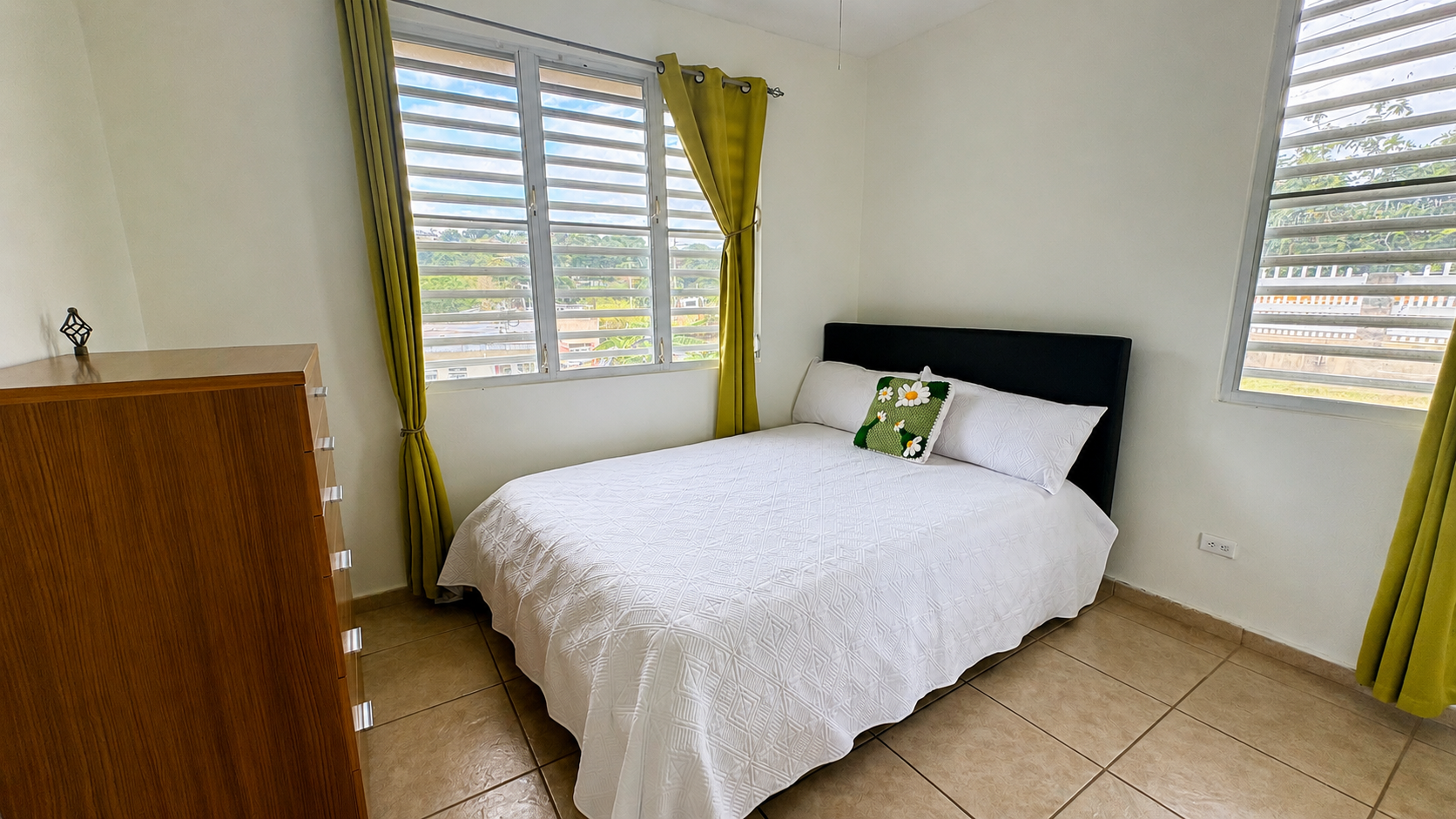 Bright guest bedroom with hillside views