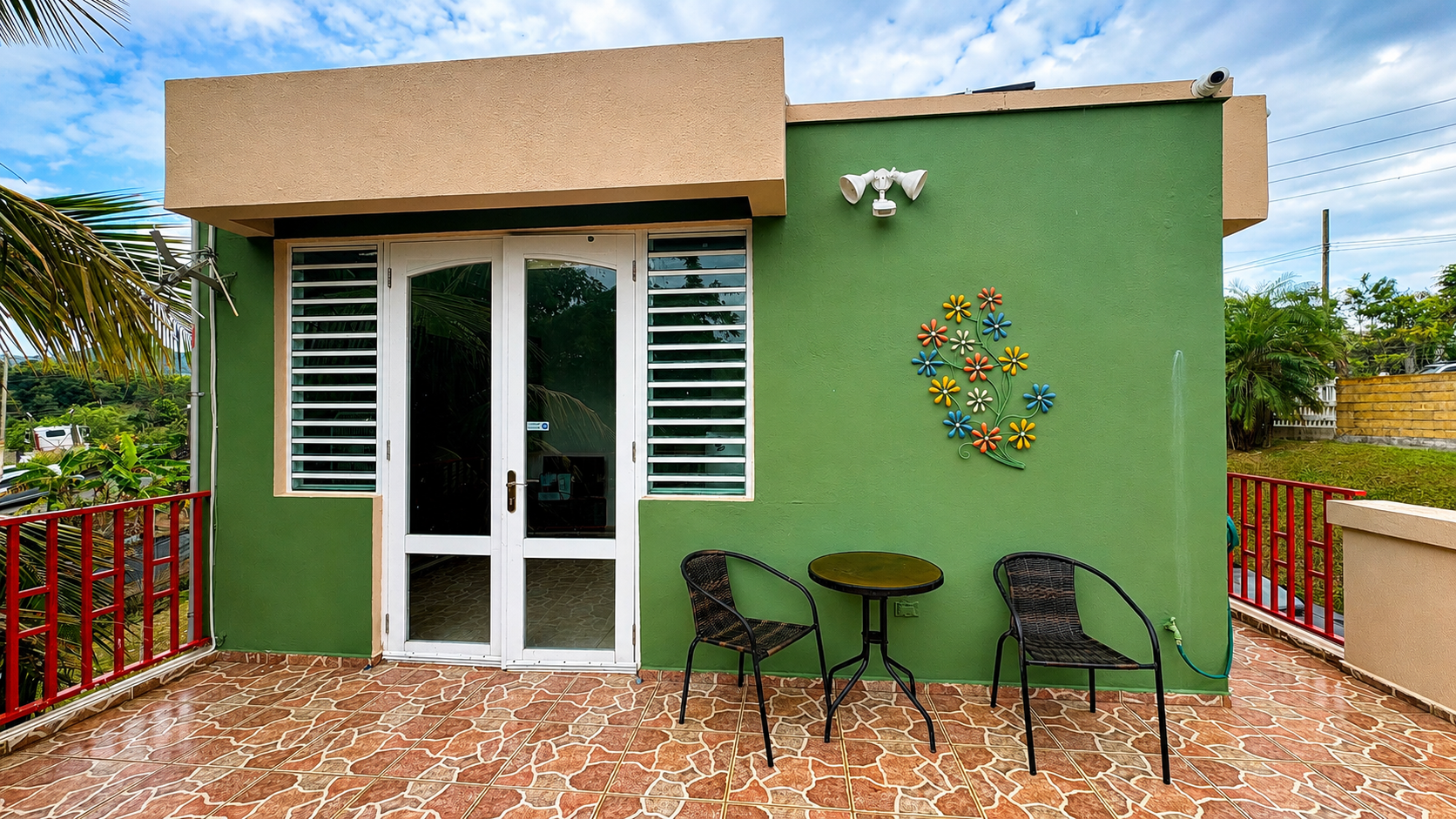 Bistro table and chairs on the tiled terrace in morning light